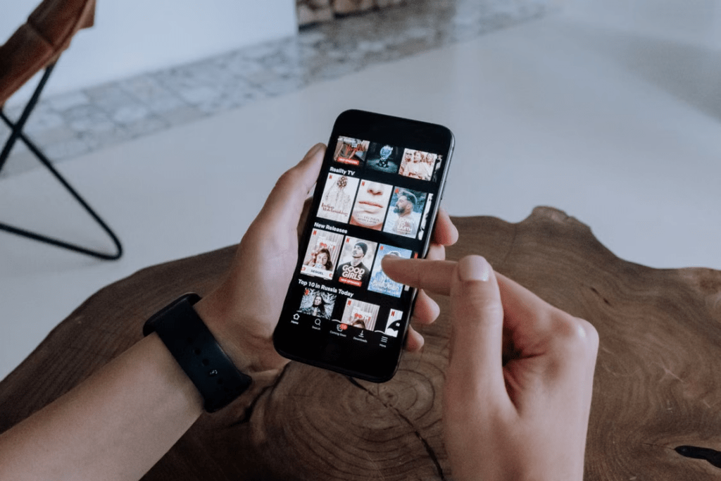Preparing a smartphone for offline movie downloads with preferred audio and subtitle settings.