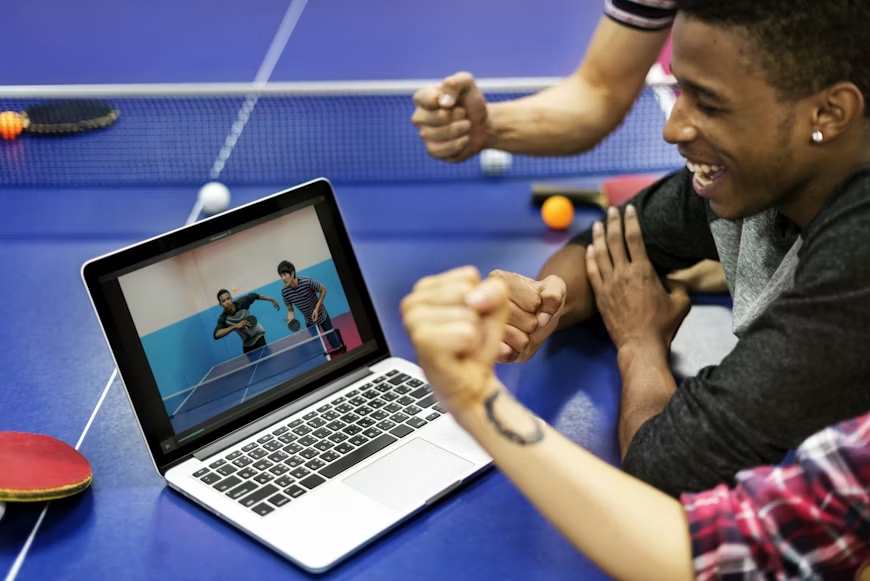 Person checking an official sports competition website for an updated match schedule after a fixture change.